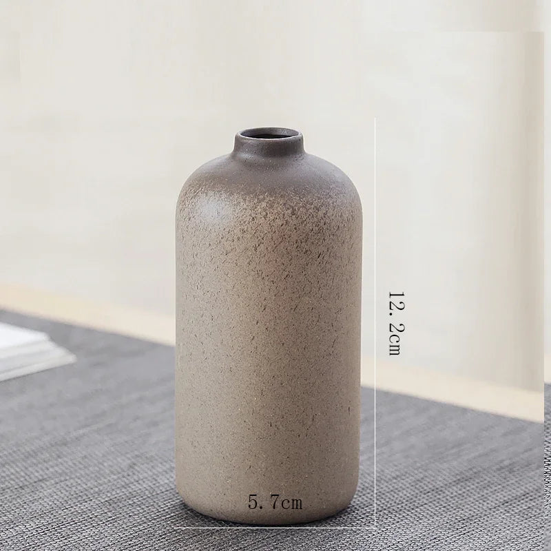 Artisan style H Chinese bud vase photographed from above on wooden surface