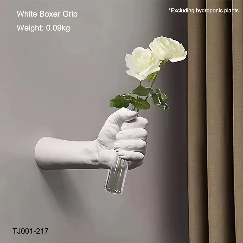 Resin wall vase in boxer pose styled next to framed prints on feature wall