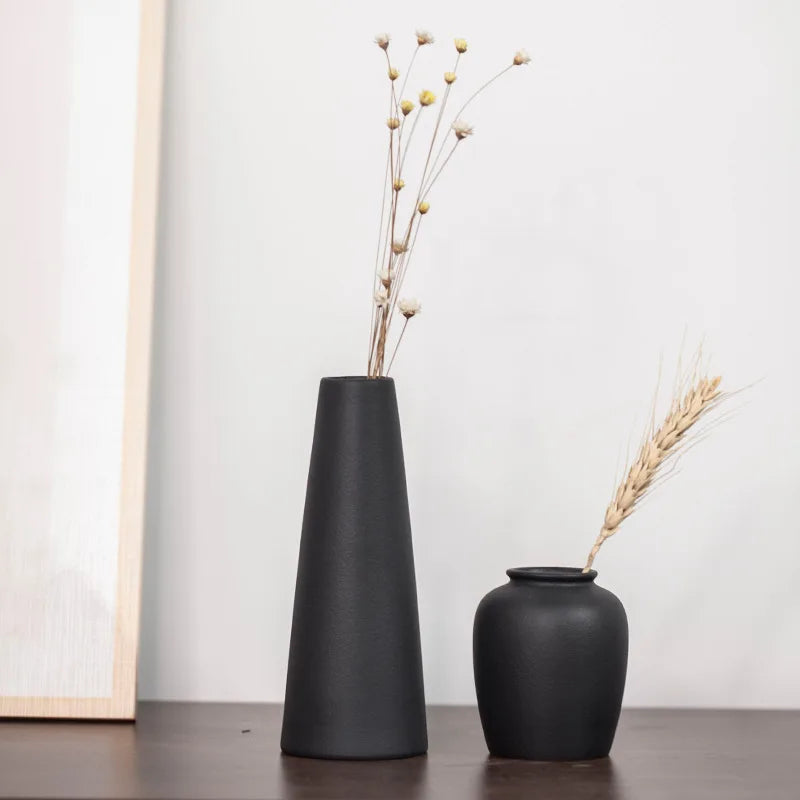Two small frosted matte ceramic vases grouped together as a shelf vignette display