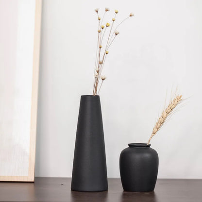 Two small frosted matte ceramic vases grouped together as a shelf vignette display