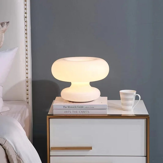 Art Deco glass table lamp with geometric silhouette casting a warm LED glow on a styled side table