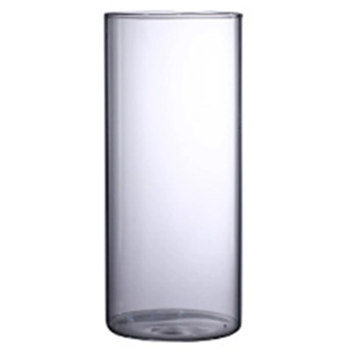 Small glass cylinder vase on bedroom nightstand holding single dried cotton flower
