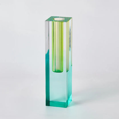 Overhead flat lay of frosted acrylic bud vases in multiple pastel color options