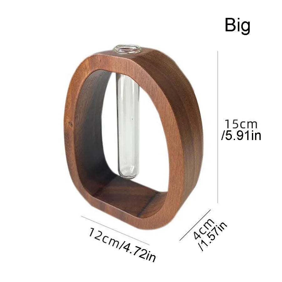 Two hydroponic wood base glass vases in black and brown displayed side by side