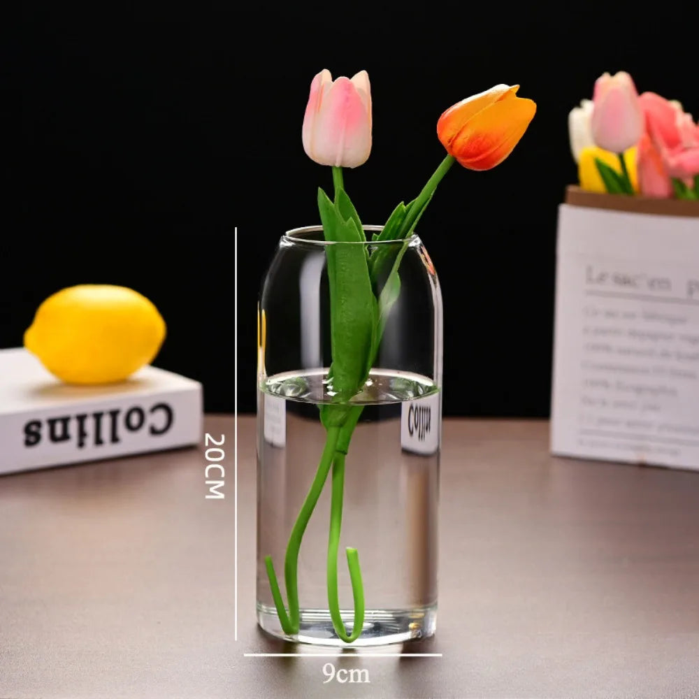 Three-piece glass vase set arranged in staggered height row on shelf