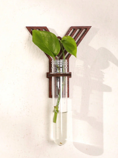 Letter propagation station on natural wood desk with other plant accessories
