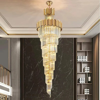 Multi layer crystal chandelier lit in warm light down a tall space