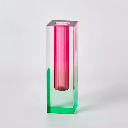 Pair of frosted pillar bud vases in mismatched heights grouped on a shelf