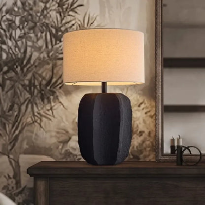 White clay pottery lamp casting warm light in Japanese retro bedroom