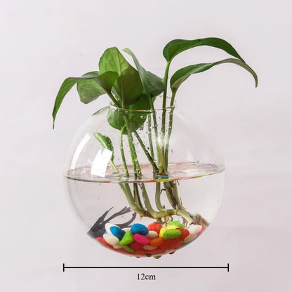 Spherical glass wall vase reflecting light on minimalist white bedroom wall
