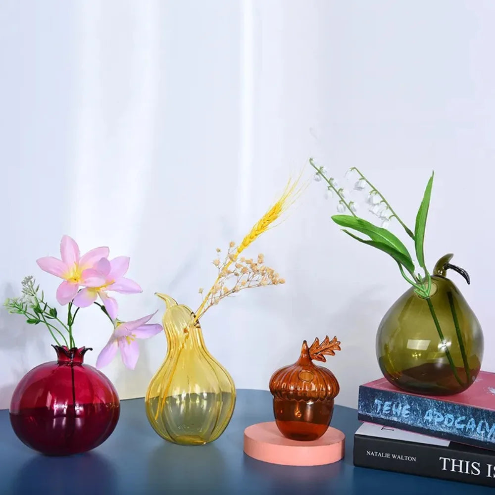 Glass pear-shaped vase with single fresh stem against white background