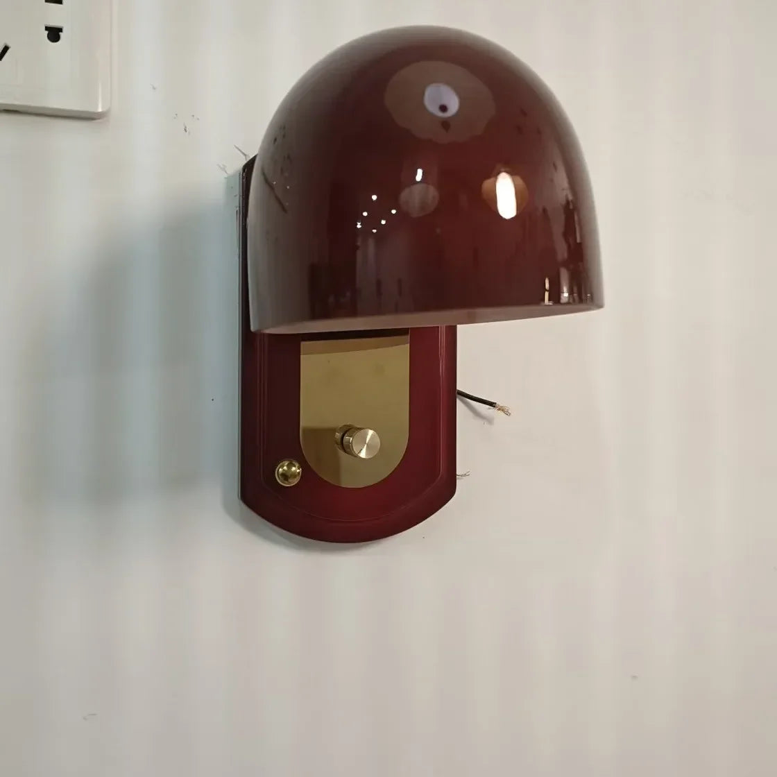 glass wall sconce, detail view of fixture base and arm