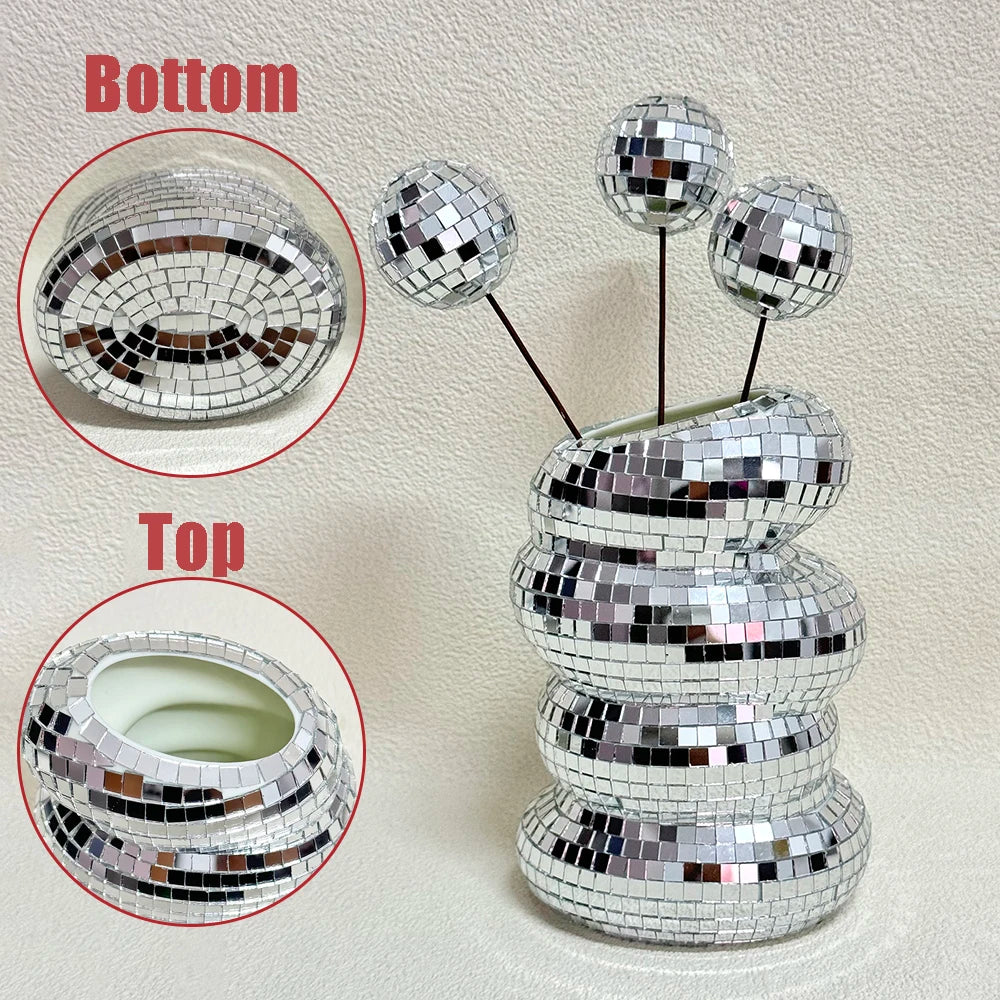 Disco ball glass vase filled with dried pampas stems on a dark shelf