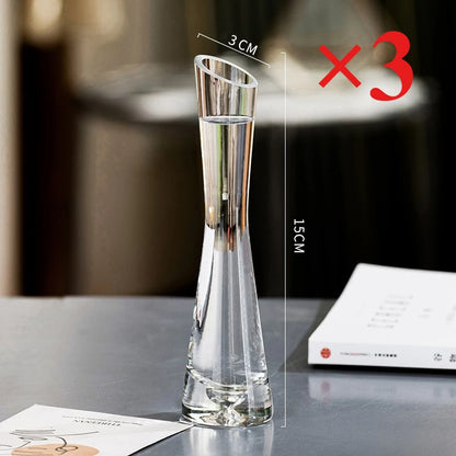 Pair of slanted glass vases in different styles displayed together