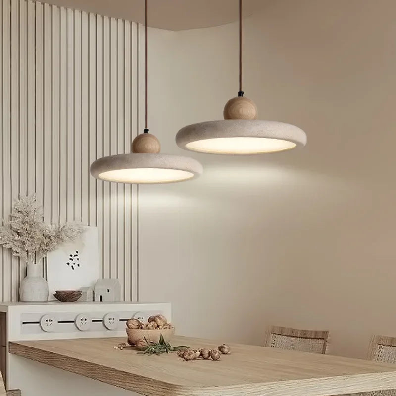 Natural stone chandelier glowing warmly through its pitted grain