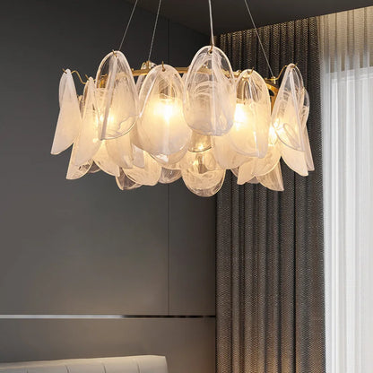Clear glass shades on a gold chandelier frame, light facing downward
