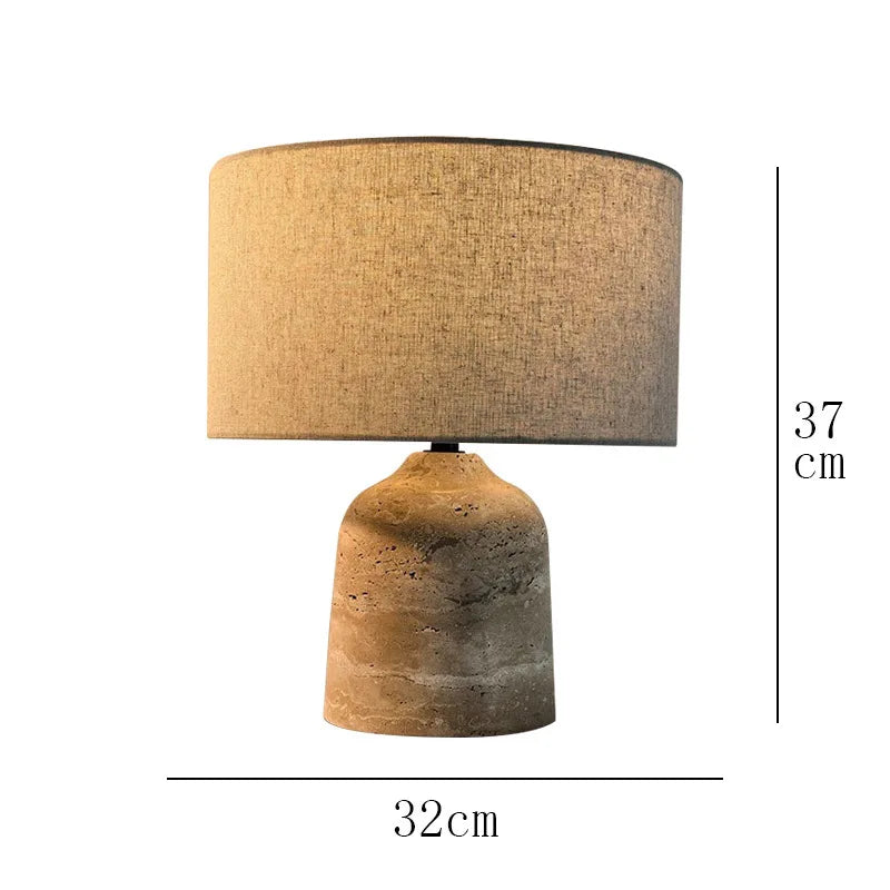 Marble stone base table lamp illuminated on study desk with warm glow