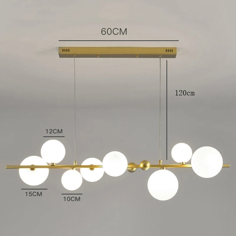 Gold ironware chandelier with clear glass shades for a kitchen island