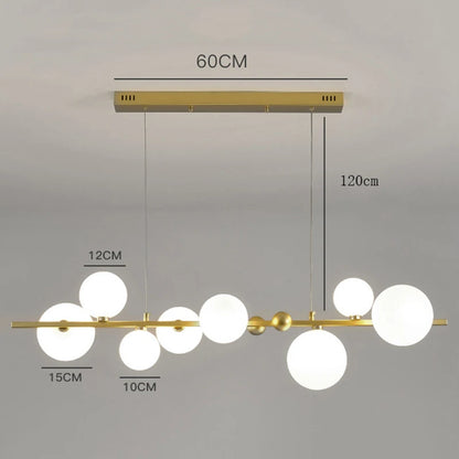 Gold ironware chandelier with clear glass shades for a kitchen island