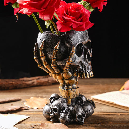 Silver-black steampunk skull resin vase with mechanical detail on dark shelf