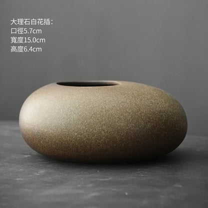 Close-up texture detail of imitation stone matte finish on terracotta vase