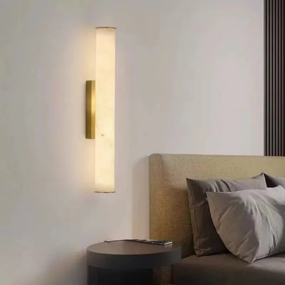 black marble wall sconce, installed in a room interior setting
