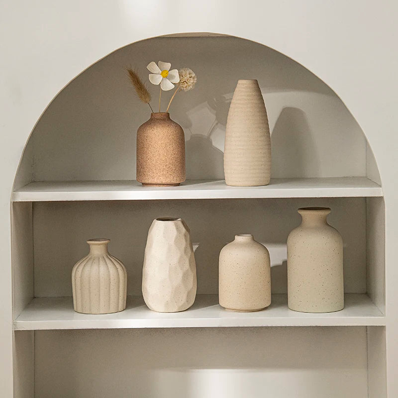 Retro ceramic flower vase with dried arrangement on desk
