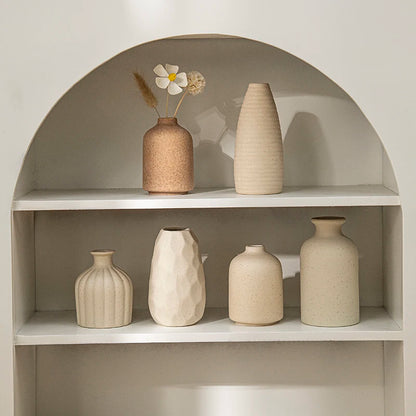 Retro ceramic flower vase with dried arrangement on desk