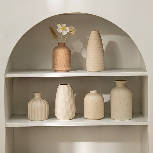 Retro ceramic flower vase with dried arrangement on desk