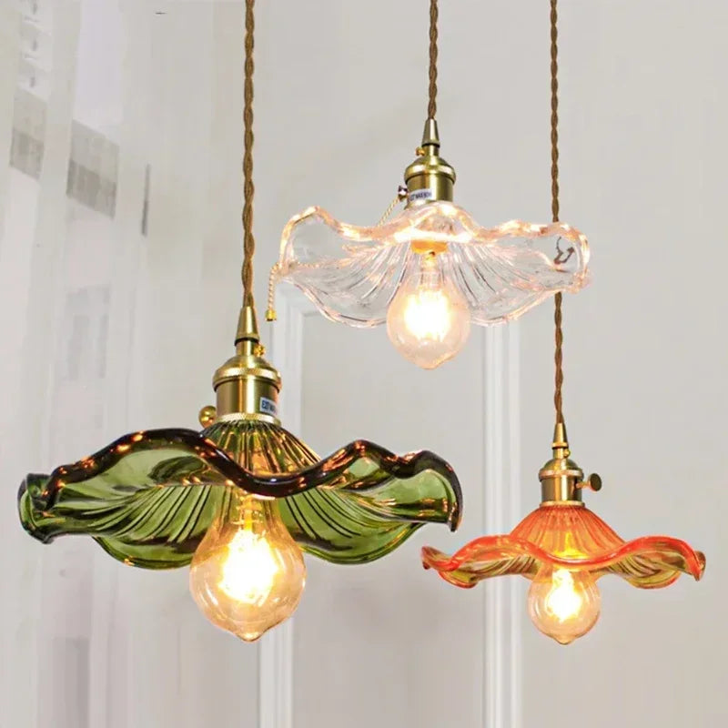 Colored glass chandelier with a single tinted shade on a polished copper fitting