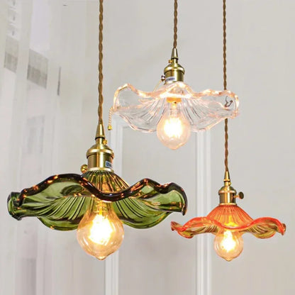 Colored glass chandelier with a single tinted shade on a polished copper fitting