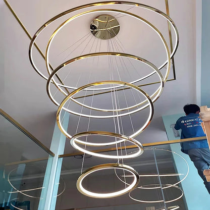 Tiered metal ring chandelier with concentric lit rings in a gold finish