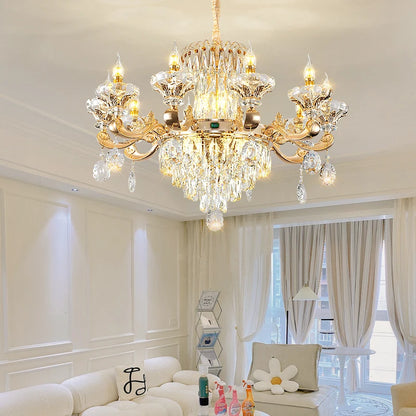 Gold finish crystal chandelier with upright candle sleeves and G9 LED bulbs