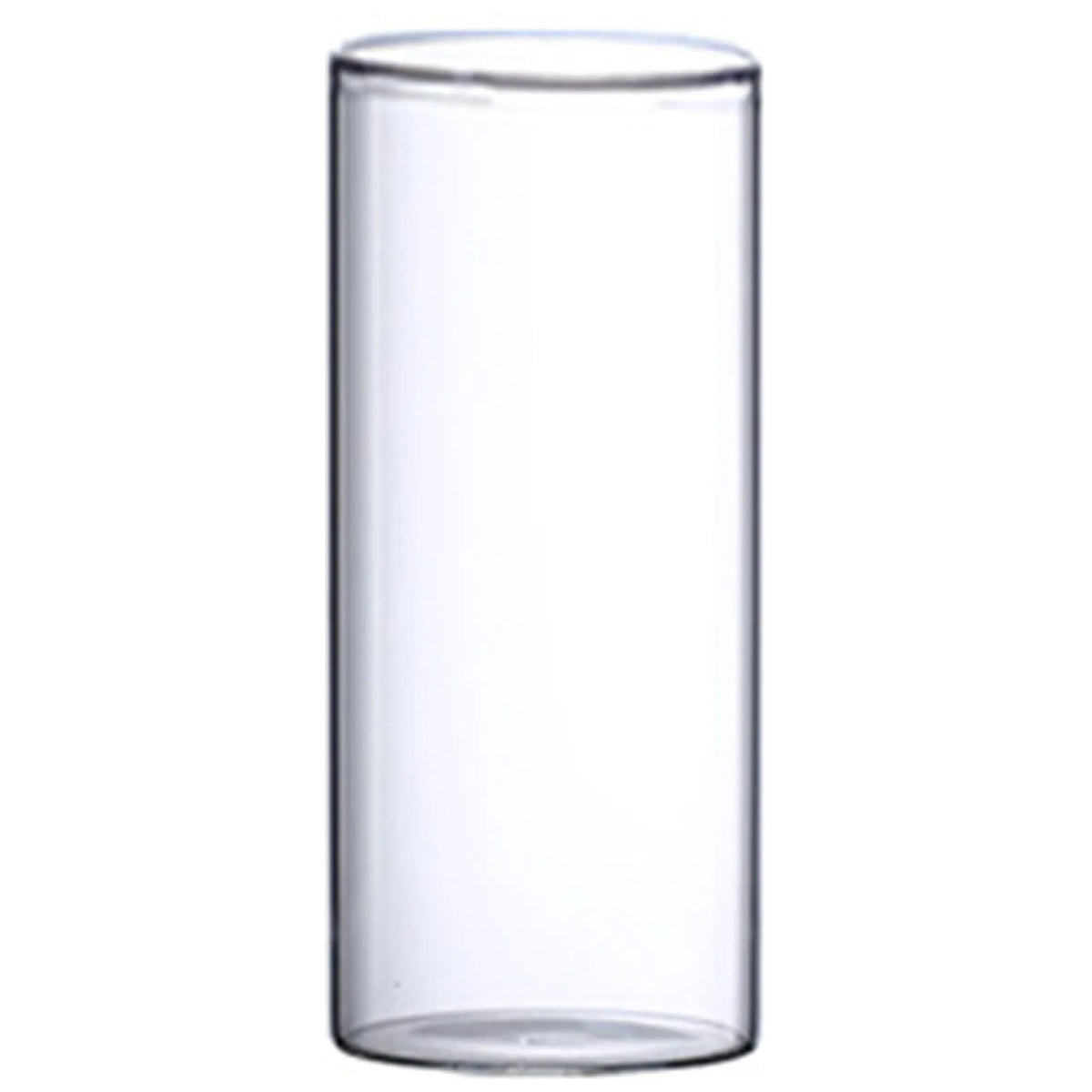Modern glass cylinder vase with wildflower stems on bathroom shelf beside round mirror