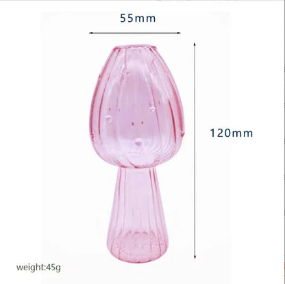 Crystal glass mushroom vase with single fresh flower on shelf