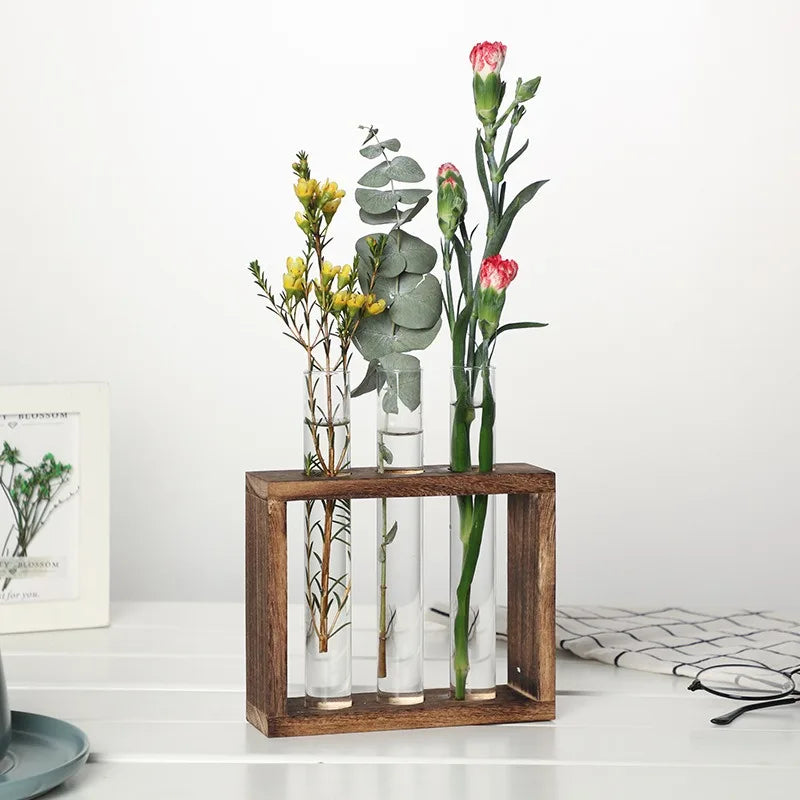 Three-tube glass hydroponic planter mounted on wooden wall stand