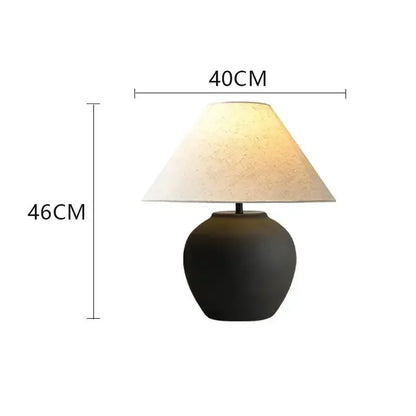 Ceramic table lamp side profile showing organic form and shade junction