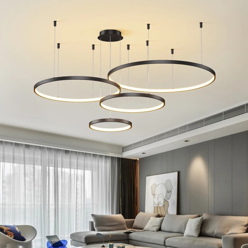 White stacked ring chandelier glowing in continuous bands of light