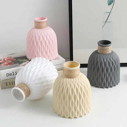 Gray plastic wave-textured vase with dried flowers on modern living room shelf