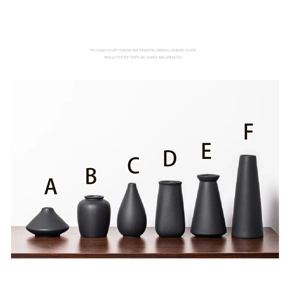 Style F matte frosted ceramic bud vase holding single cotton stem on wooden ledge
