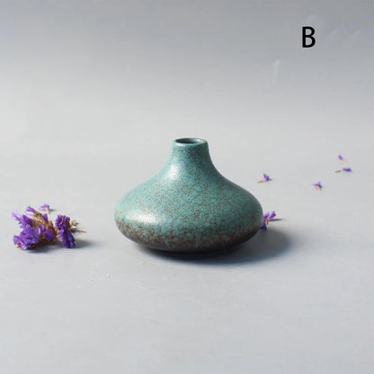 Side profile of style C Japanese ceramic small vase on white surface