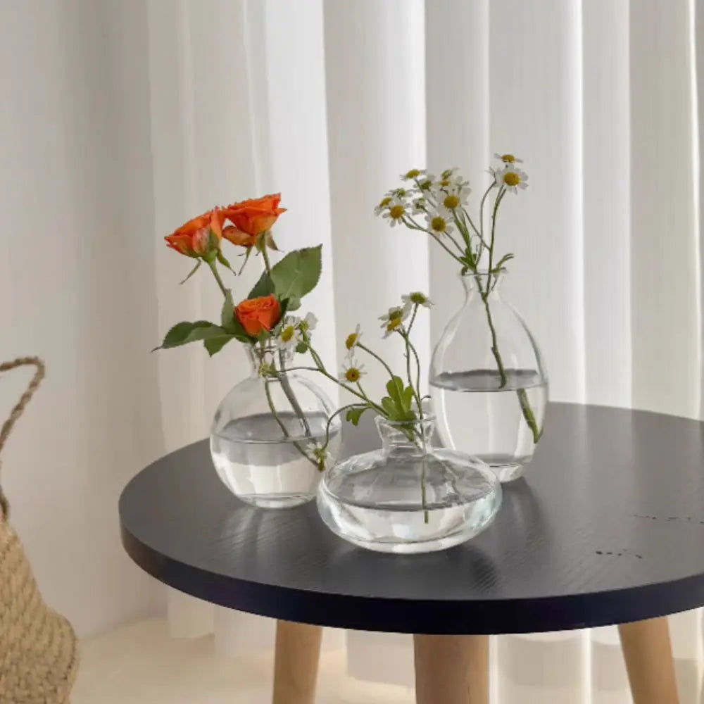 Mini grey glass vase with fresh flower on Nordic shelf display