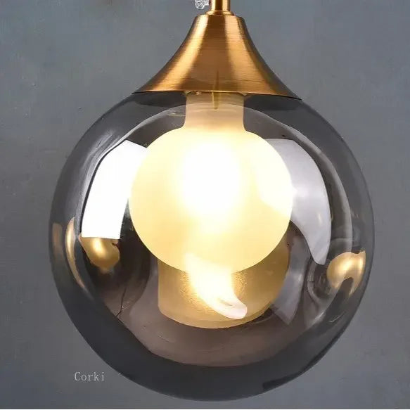 gold glass wall sconce, detail view of fixture base and arm