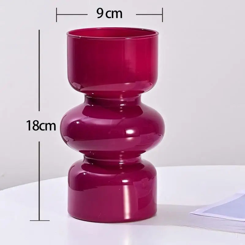 Overhead flatlay of Nordic retro glass vases in five color options on white surface