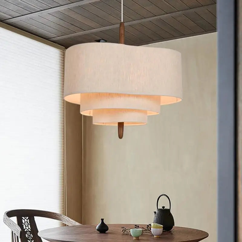 Woven pebble fabric chandelier with a hand knitted beige cloth shade