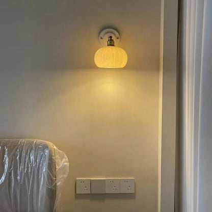 brass wall sconce, detail view of fixture base and arm