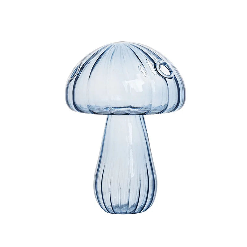 Crystal glass mushroom vase with dried botanical stem on desk