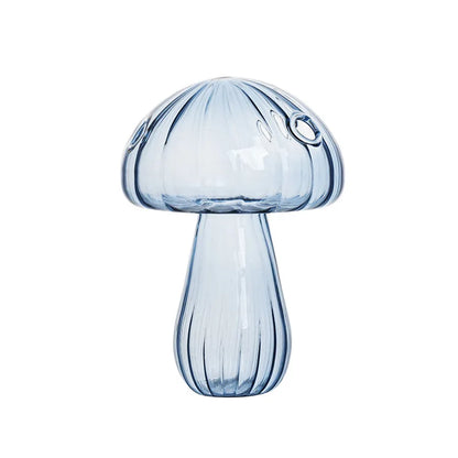 Crystal glass mushroom vase with dried botanical stem on desk
