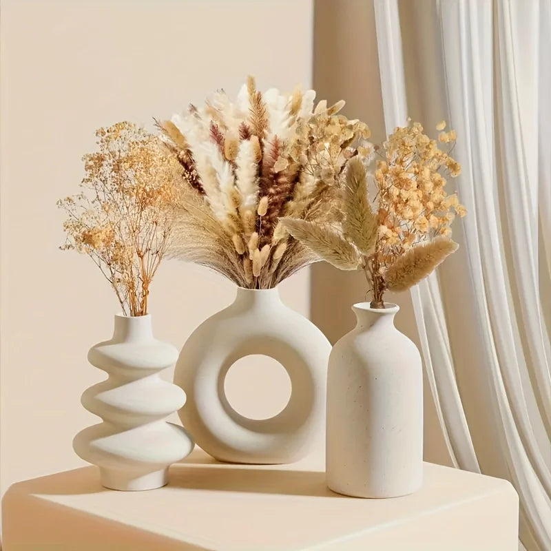 Bohemian ceramic three-piece vase set in white glaze on white background