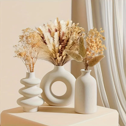 Bohemian ceramic three-piece vase set in white glaze on white background